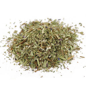 A pile of dried herbs on top of a white surface.