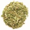 A pile of green leaves on top of a white surface.